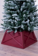 Snowy tree with red Christmas tree skirt